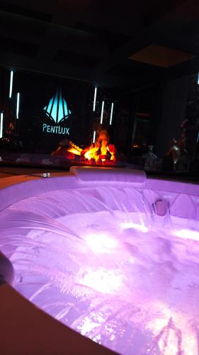 a hot tub with a fire in the background at PentLux - SPA Penthouse in the heart of Skopje in Skopje