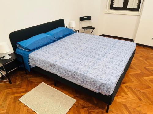 a bedroom with a large bed with blue pillows at Casa Vacanze Angelina in Trieste