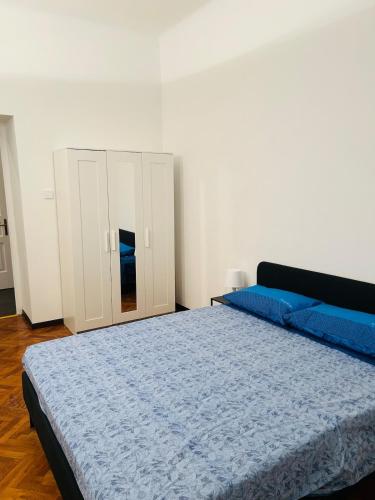 a bedroom with a bed and a white cabinet at Casa Vacanze Angelina in Trieste
