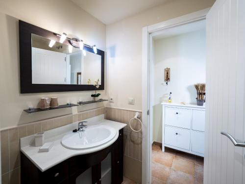 a bathroom with a sink and a mirror at Los Pelicanos by Ĥ - Playa Punta del Moral PLHC39P38 in Isla del Moral
