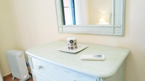 a white dresser with a mirror on top of it at El Rincón del Golf I by Ĥ - Isla Canela Golf GRHI6P06 in Isla Canela