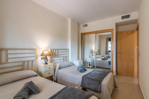 A bed or beds in a room at Playa Marina by Ĥ