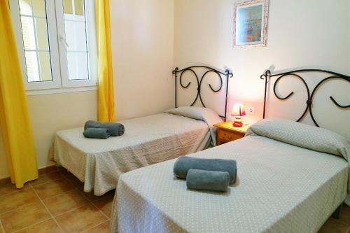 a room with two beds with towels on them at Canela Park by Ĥ - Playa Isla Canela ICHP34P3 in Isla Canela