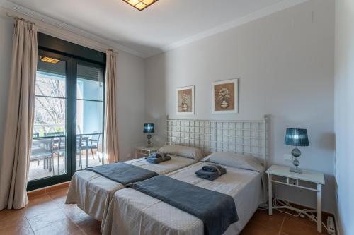 A bed or beds in a room at El Rincon del Golf II by Ĥ - Isla Canela Golf GRHII18P21