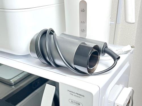 a large appliance on a shelf in a refrigerator at Discover Fukuoka House in Fukuoka