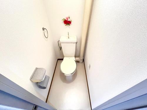 a small bathroom with a toilet in a stall at Discover Fukuoka House in Fukuoka