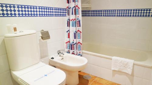 a bathroom with a toilet and a sink and a tub at Marina III by Ĥ - Marina Isla Canela PMHIII12P13 in Isla del Moral