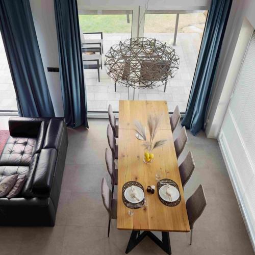 a wooden table in a living room with a couch at LasMinute - stodoła z prywatną balią in Kazimierzów