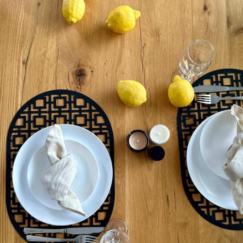 a wooden table with two plates of food and lemons at LasMinute - stodoła z prywatną balią in Kazimierzów