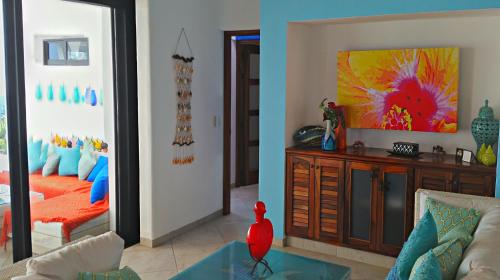 a living room with a couch and a tv at Villa Star of the Sea in Barra de Navidad