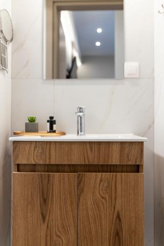 a bathroom with a sink and a mirror at Zerynthos Apartments in Therma