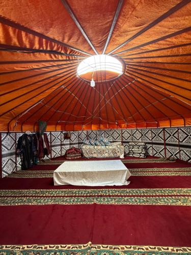 a room with a bed and a light in a tent at Юрты РАЯНА in Kurmenty