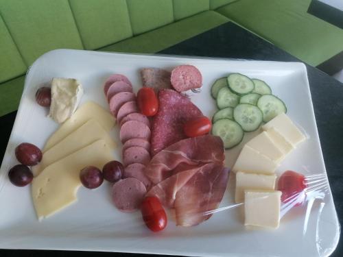 a plate of food with meats and cheese on it at Vis Saar Vie - Ferienwohnungen an der Saarschleife in Mettlach