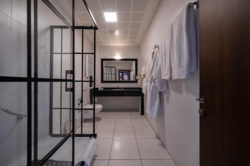 a bathroom with a sink and a toilet and a mirror at Iris Hotel & Spa in Canakkale