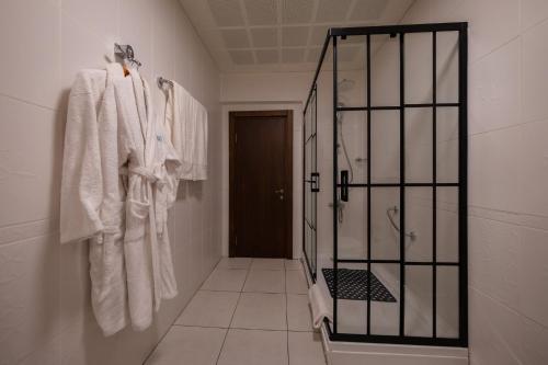 a bathroom with white towels hanging on a wall at Iris Hotel & Spa in Canakkale