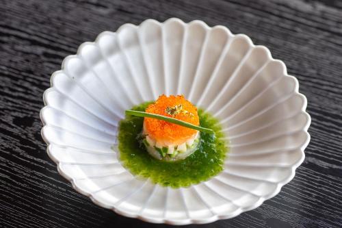 a white plate with a piece of food on it at Wanosato in Takayama