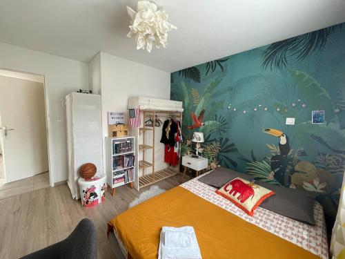 a bedroom with a bed and a tropical themed wall at Villa Harmony Climatisation Piscine semi enterrée Wifi Camargue in Saint-Just