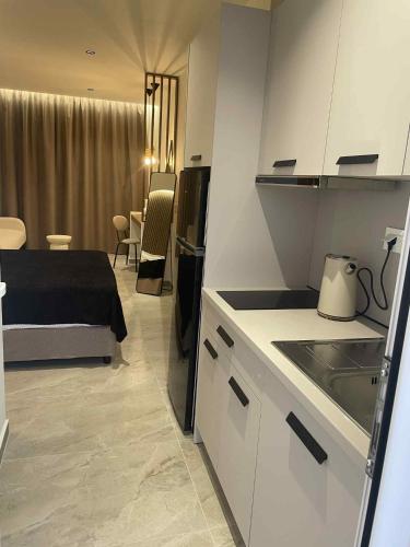 a kitchen and a bedroom with a bed in a room at Kostas Studios in Faliraki