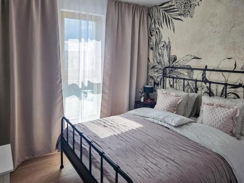 une chambre avec un grand lit et une fenêtre dans l'établissement Kairos Apartments -Atos - darmowy parking, klimatyzacja, à Olsztynek