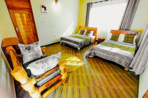 a living room with two beds and a window at Materuni Homes in Moshi