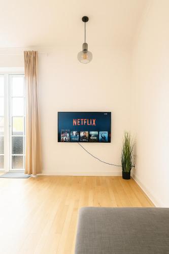 a white room with a television on the wall at Scandic Stay CPH in Copenhagen