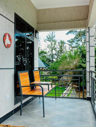 a wooden bench sitting on the porch of a building at Materuni Homes in Moshi