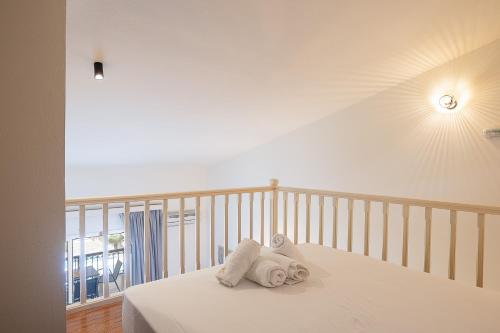 a bedroom with a bed with towels on it at Lofos Panorama Apartments in Prínos
