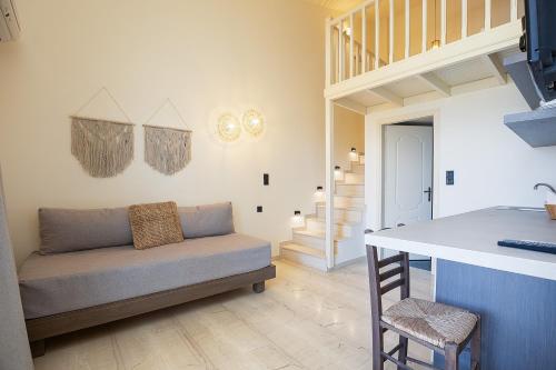 a living room with a couch and a table at Lofos Panorama Apartments in Prínos