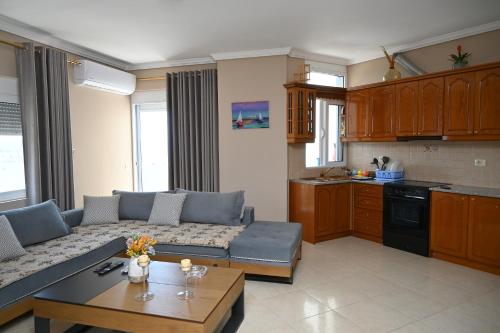 a living room with a couch and a table at Amos Apartment in Sarandë