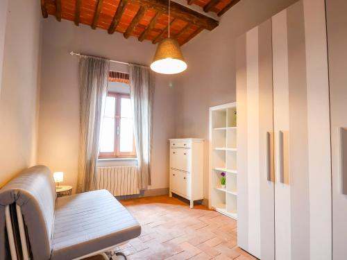 a living room with a chair and a window at Tuscan Nest - in Montecatini Alto in Montecatini Alto