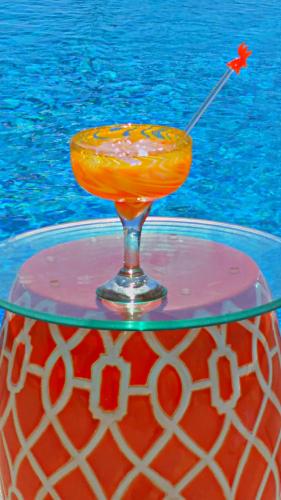a drink sitting on top of a glass table at Villa Star of the Sea in Barra de Navidad