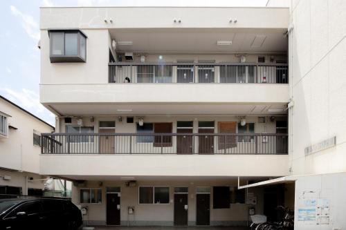an external view of a building with a balcony at Osaka U-Shuku in Osaka
