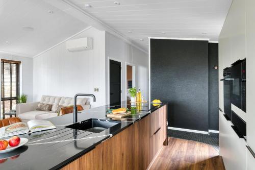 a kitchen with a black counter top and a living room at Seaham Hall and Serenity Spa in Seaham
