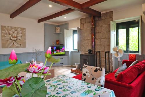 a living room with a red couch and a table at Bed and breakfast EXCLUSIVE & Luxury Traditional Portuguese Farmhouse