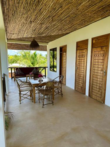 a dining room with a table and chairs at Sand Beach Boutique Apartments in Bwejuu