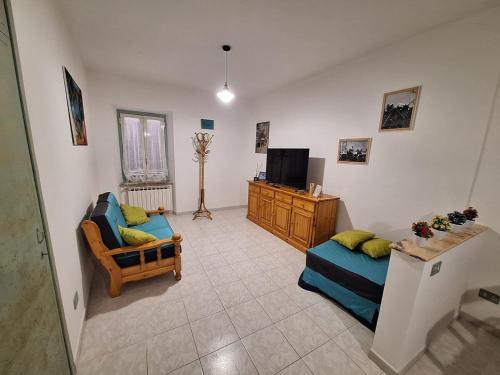a living room with two couches and a television at Alloggio Turistico Pescaxiause in SantʼOreste