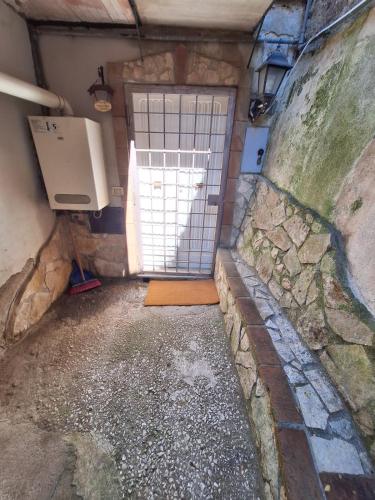 a garage with a door and a window in it at Alloggio Turistico Pescaxiause in SantʼOreste