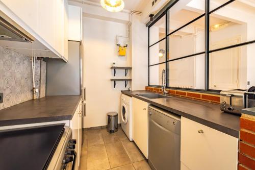 a kitchen with a sink and a dishwasher at 4 Guests Flat - Turbigo in Paris