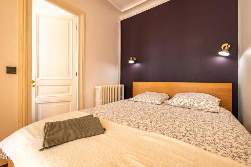 a bedroom with a large bed with two pillows at 4 Guests Flat - Turbigo in Paris