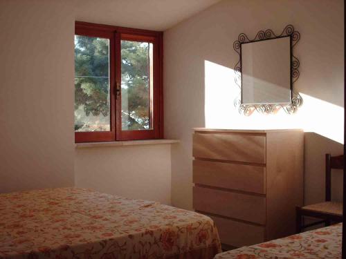 Ένα ή περισσότερα κρεβάτια σε δωμάτιο στο Villa Matassa 4 appartamenti vista mare in San Menaio
