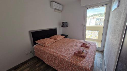 une chambre avec un lit et une grande fenêtre dans l'établissement Life in red with parking and air conditioning, à Sète