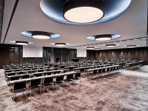 an empty room with rows of tables and chairs at Radisson Collection Hotel, Berlin in Berlin