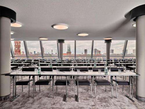 a large room with tables and chairs with a view at Radisson Collection Hotel, Berlin in Berlin