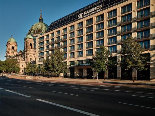 a building on the side of a street next to a road at Radisson Collection Hotel, Berlin in Berlin