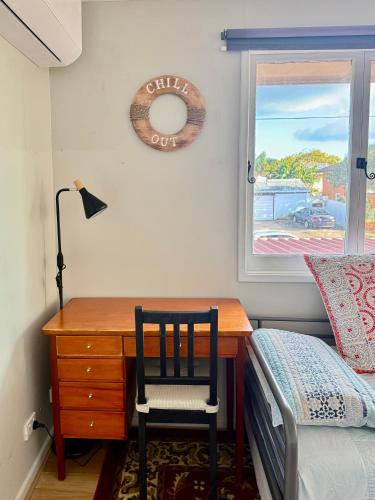 a bedroom with a desk and a bed and a window at Zen Escape Guest House " Location 1" - Three listings - Romantic Escape, Cozy Delight, Oasis Suite in Brisbane