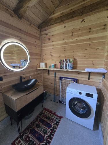 a bathroom with a washing machine and a sink at CabinAtRiver Ada Bojana in Ulcinj