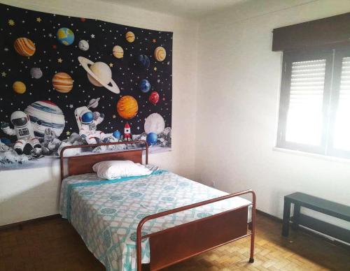 a bedroom with a bed with a astronomy mural on the wall at Lisbon Private Room near airport in Lisbon