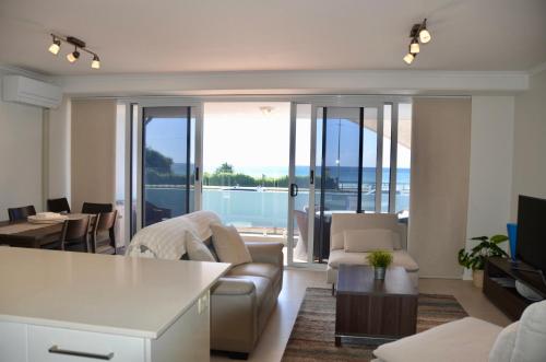 a living room with a view of the ocean at Alex Beach Apartment in Alexandra Headland