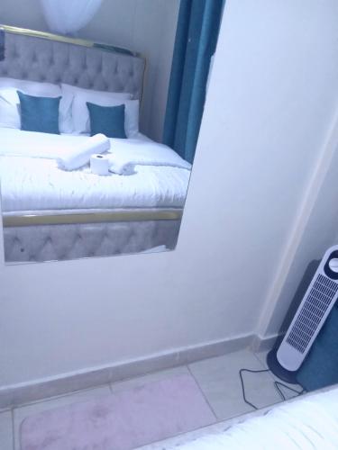 a room with a bed with aimeter at Kapere cozy room in Kisumu