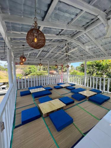 a room with blue cushioned chairs on a porch at Surfing Tusker - Arugambay in Arugam Bay